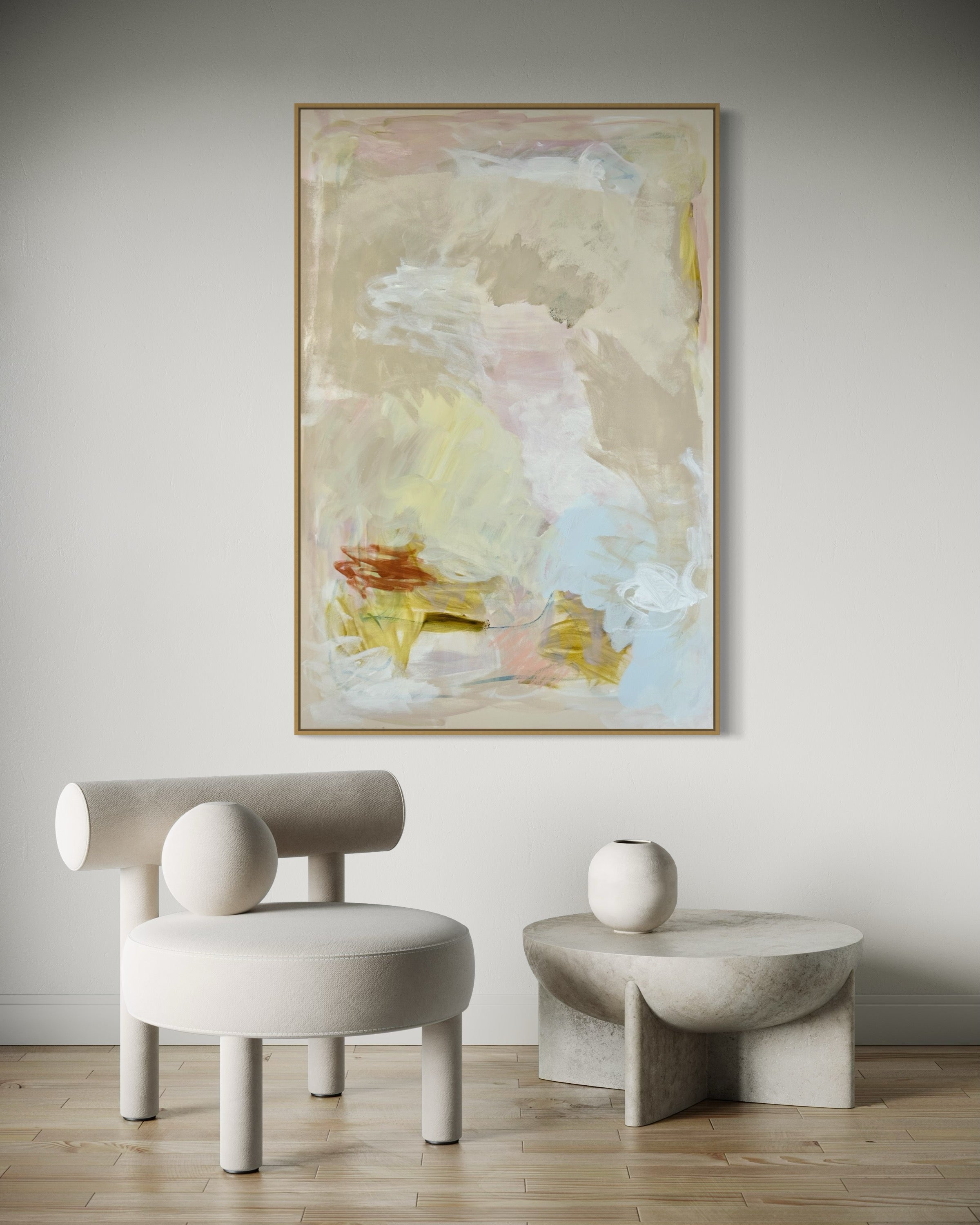 Abstract painting titled 'A Meadow And A Stream' by Sara Chamberlain, featuring soft pastel colors with yellow and red accents, framed in oak and displayed in a modern interior.